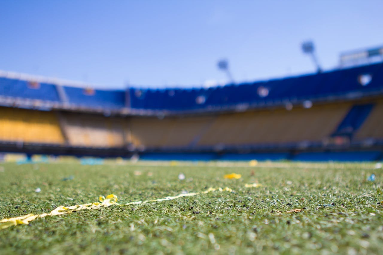 Close-up view of a vibrant football pitch in a sunlit Buenos Aires stadium, perfect for sports enthusiasts.